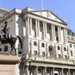 Bank of England building with digital stablecoin icons