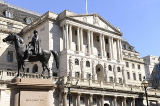 Bank of England building with digital stablecoin icons