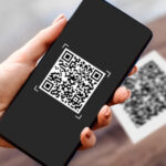 Customer using cryptocurrency payment via QR code at South African retail store