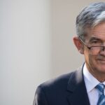 Jerome Powell delivering a speech on economic outlook, impacting crypto and stocks
